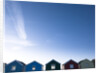 Beach huts in a row against blue skies by Assaf Frank